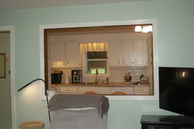 a living room with furniture and stairs