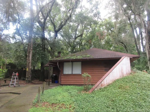 a view of a backyard with large trees