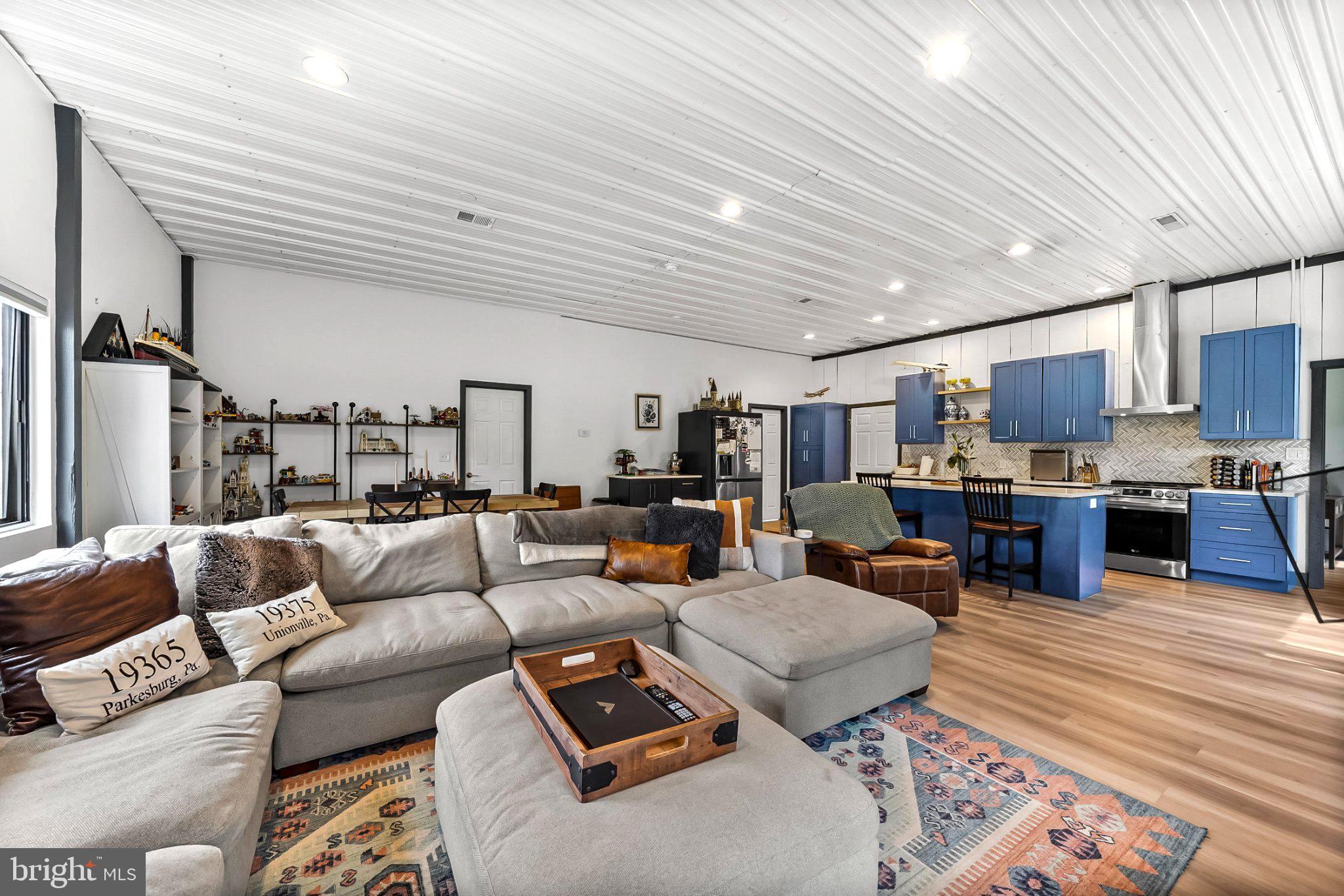 928 Stargazer Road Coatesville, PA 19320 - Photo 13 of 22 a living room with furniture kitchen view and a wooden floor