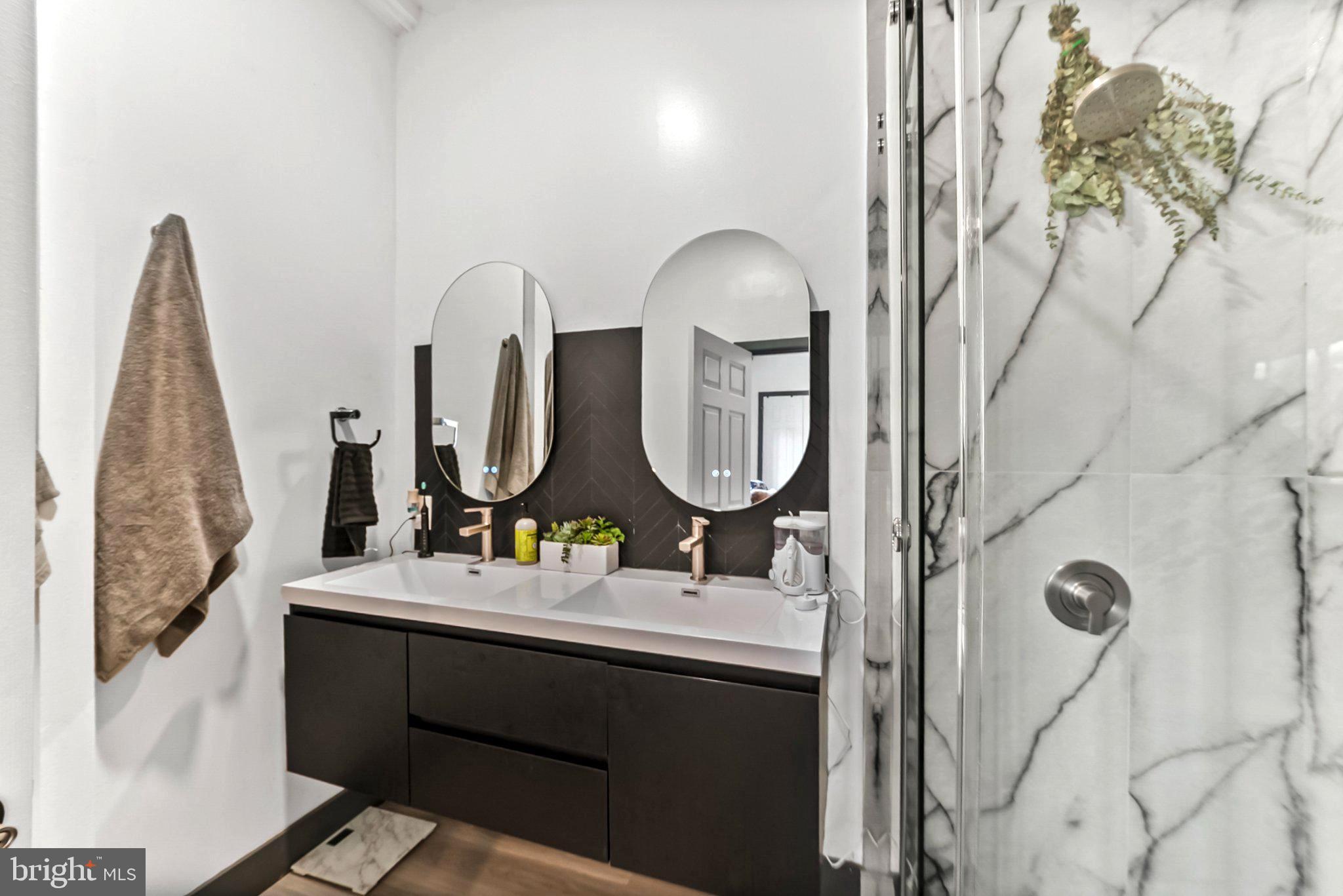 928 Stargazer Road Coatesville, PA 19320 - Photo 16 of 22 a bathroom with a double vanity sink and a mirror