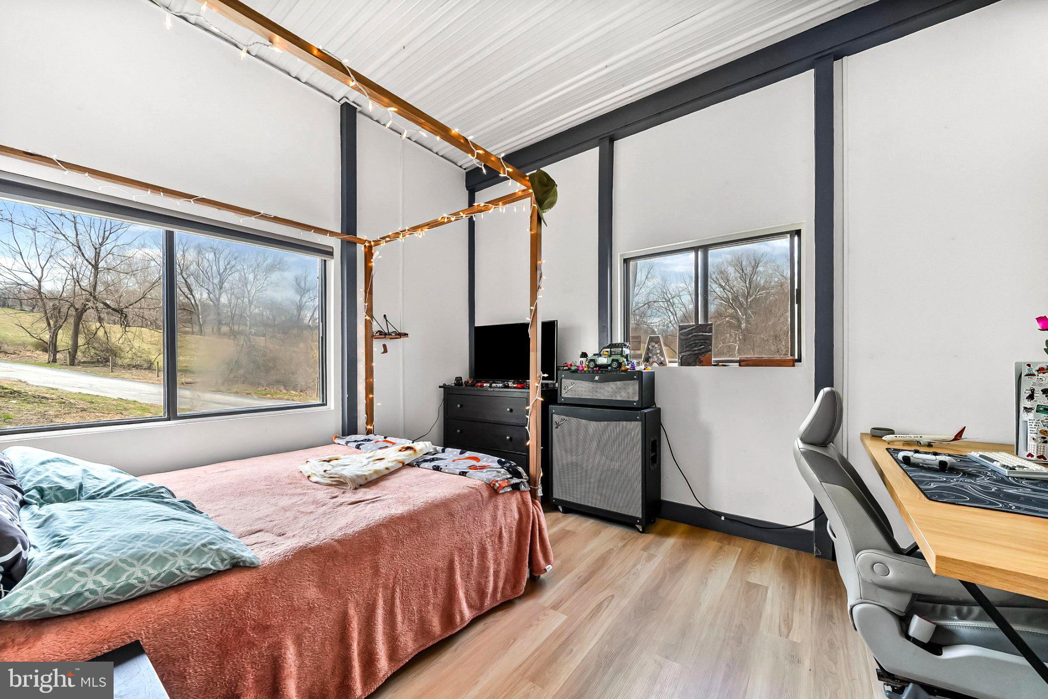 928 Stargazer Road Coatesville, PA 19320 - Photo 17 of 22 a bedroom with a bed wooden floor and a large window