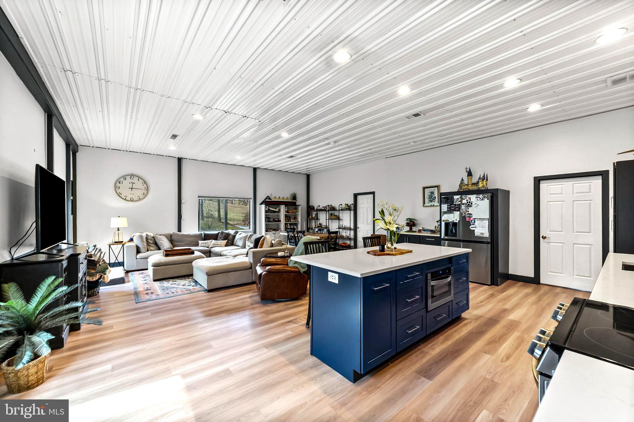 928 Stargazer Road Coatesville, PA 19320 - Photo 10 of 22 a large living room with stainless steel appliances granite countertop couches a flat screen tv