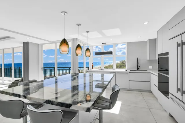 a kitchen with stainless steel appliances white cabinets and a refrigerator