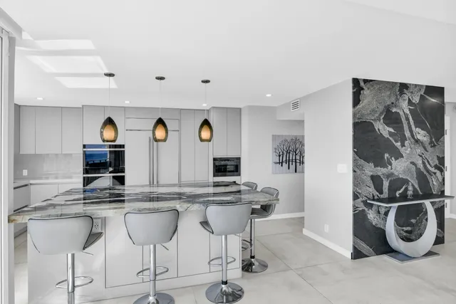 a bedroom with furniture and large windows