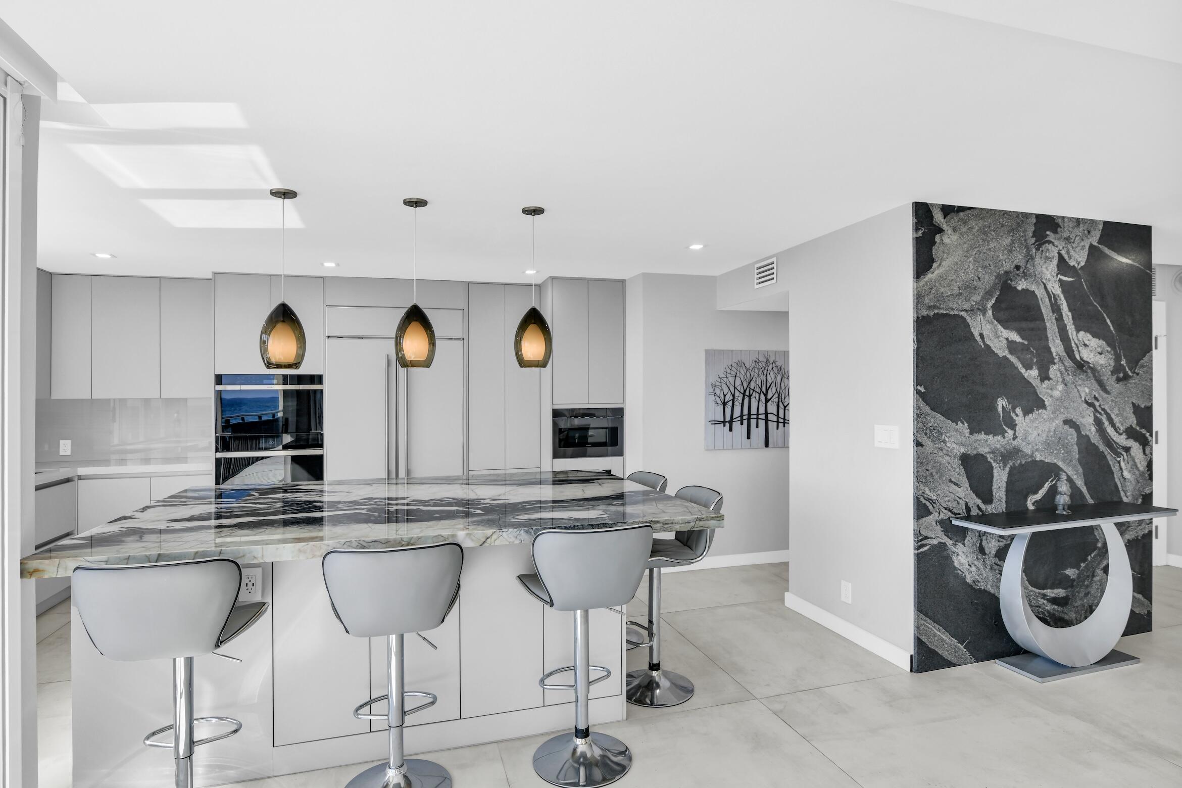 2000 South Ocean Boulevard, Unit 6K Boca Raton, FL 33432 - Photo 15 of 94 a kitchen with stainless steel appliances granite countertop a sink and a refrigerator