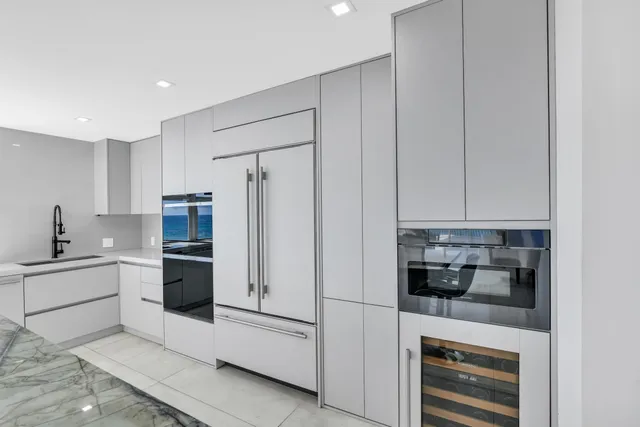 a spacious bedroom with a bed and a flat screen tv