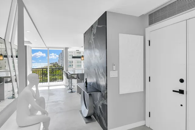 a dining room with furniture and a floor to ceiling window