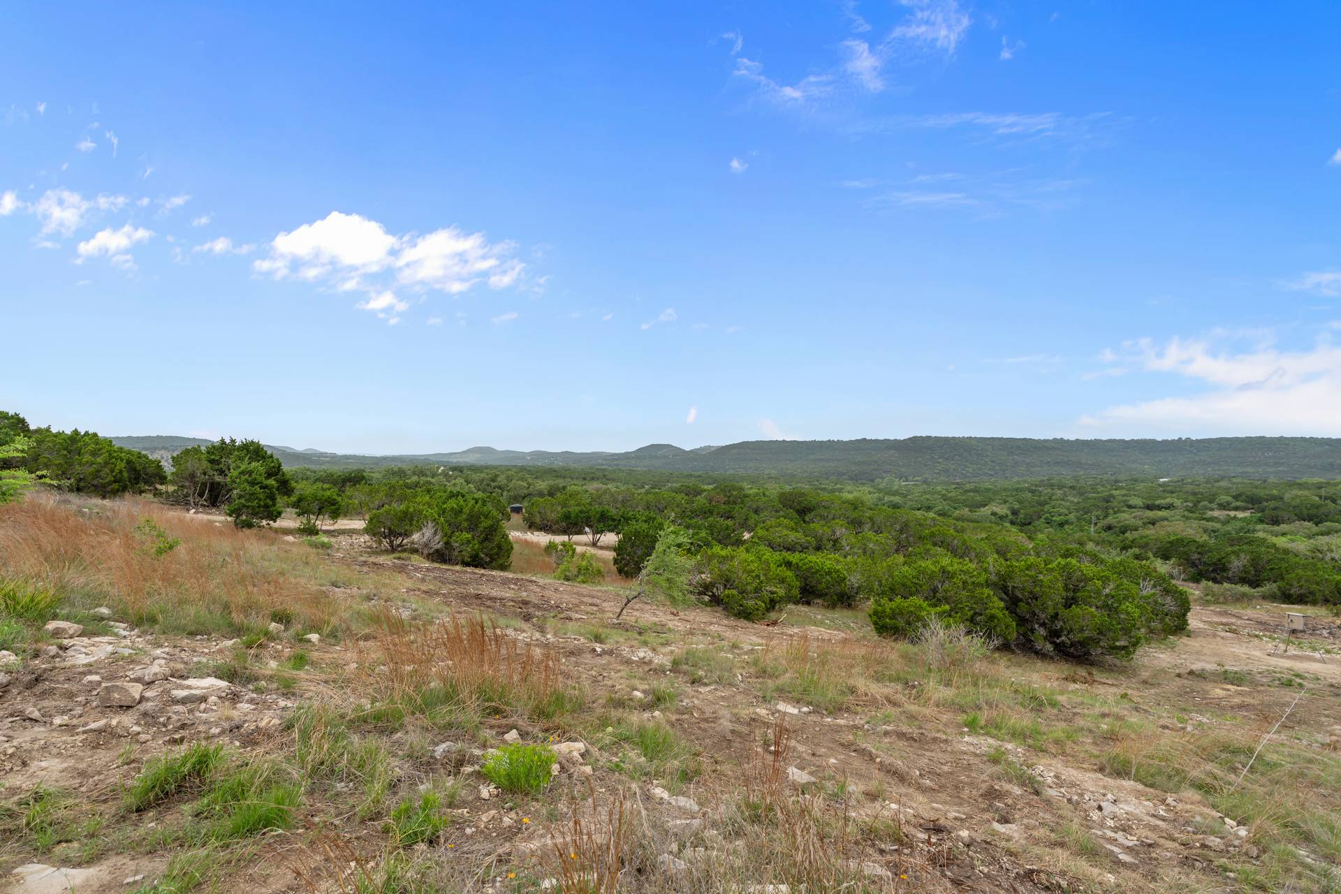 182 Quail Creek Road Marble Falls, TX 78654 - Photo 15 of 20 a view of a lake with mountains in the background