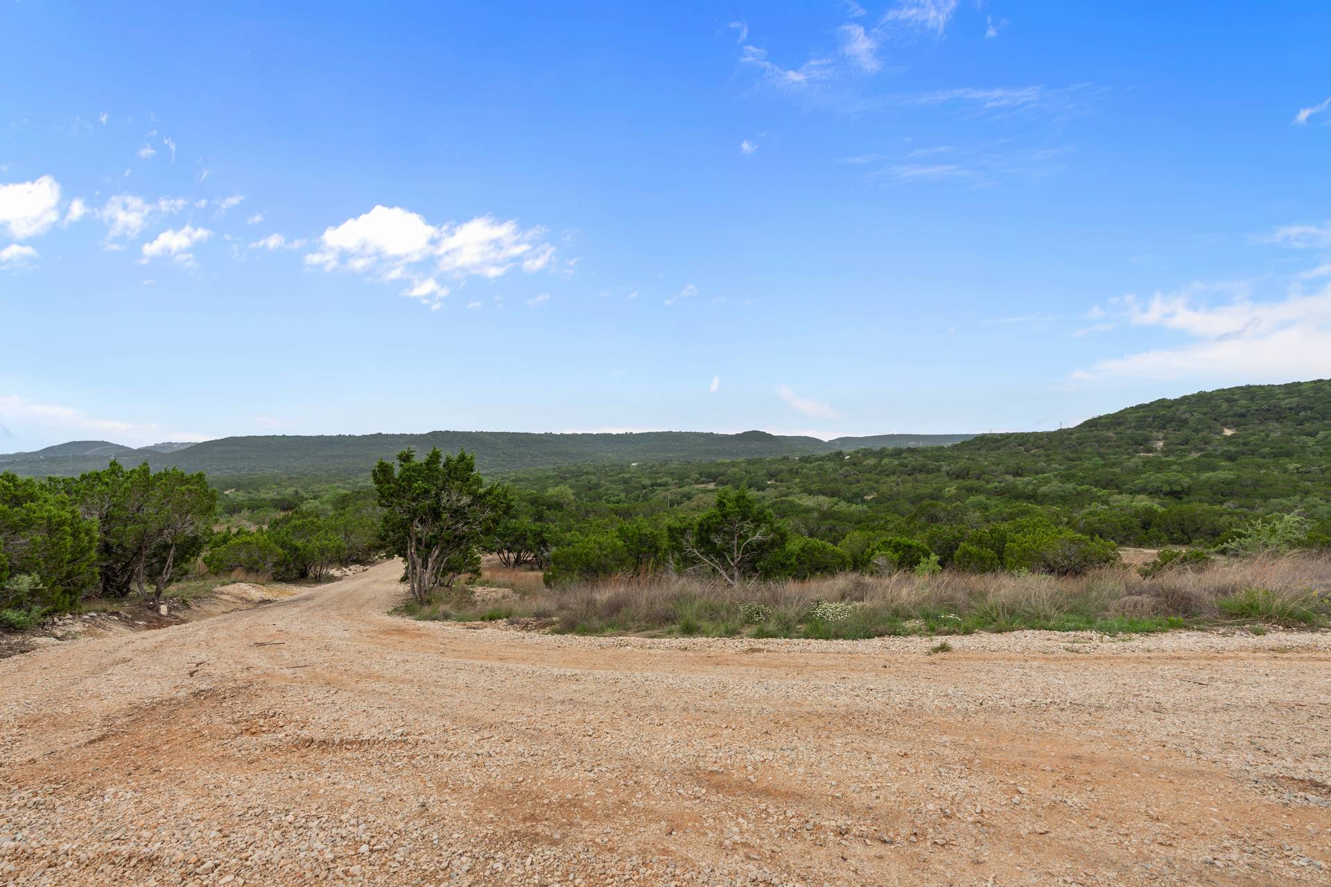 182 Quail Creek Road Marble Falls, TX 78654 - Photo 3 of 20 a view of a lake with mountains in the background