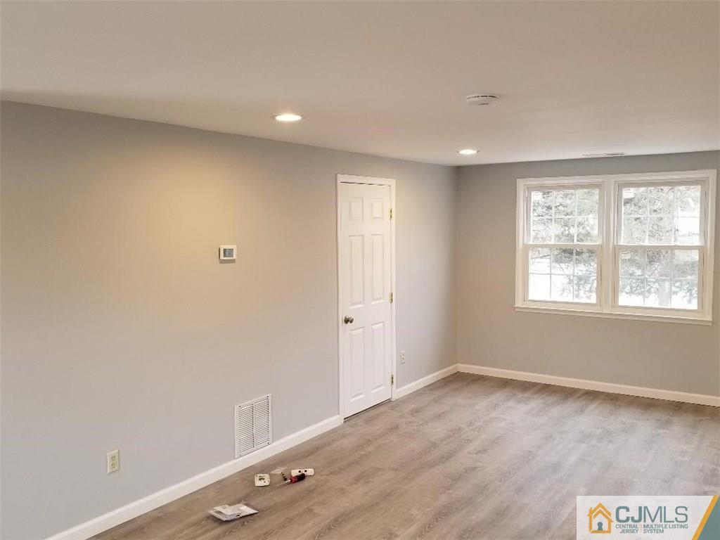 29 Hill Road Edison, NJ 08817 - Photo 3 of 15 an empty room with wooden floor and windows