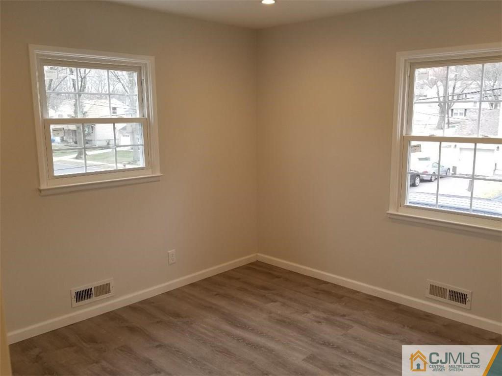 29 Hill Road Edison, NJ 08817 - Photo 8 of 15 an empty room with wooden floor and windows