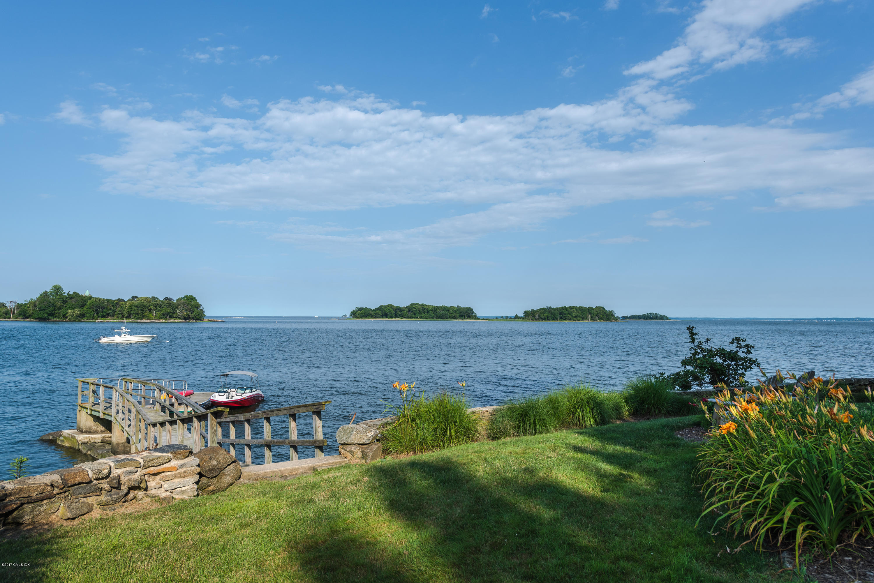 147 Byram Shore Road Greenwich, CT 06830 - Photo 17 of 19 a view of a lake with houses in the back