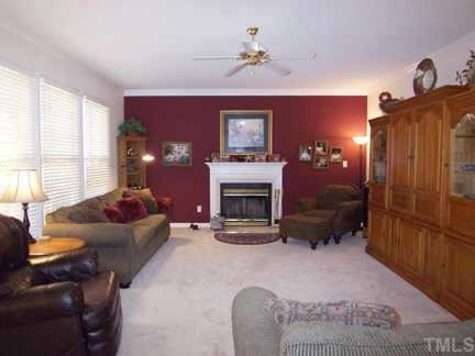 2905 Funster Lane Raleigh, NC 27615 - Photo 5 of 12 Open to the KIT is the lg Family Rm w/like-new neutral carpet, ceiling fan, FP w/tile surround & white wood mantle, triple windows & door to the Deck and backyard. Other