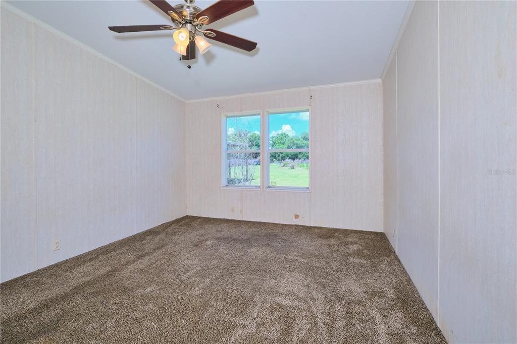 2701 Murphy Road Ona, FL 33865 - Photo 25 of 41 an empty room with windows and ceiling fan