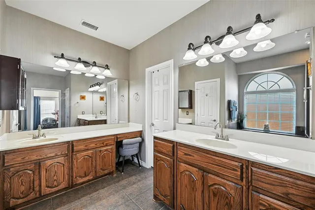 a bathroom with a sink mirror and a bathtub with double