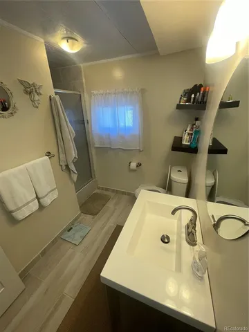 a bathroom with a tub sink and mirror