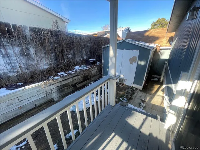 a view of a backyard with wooden fence