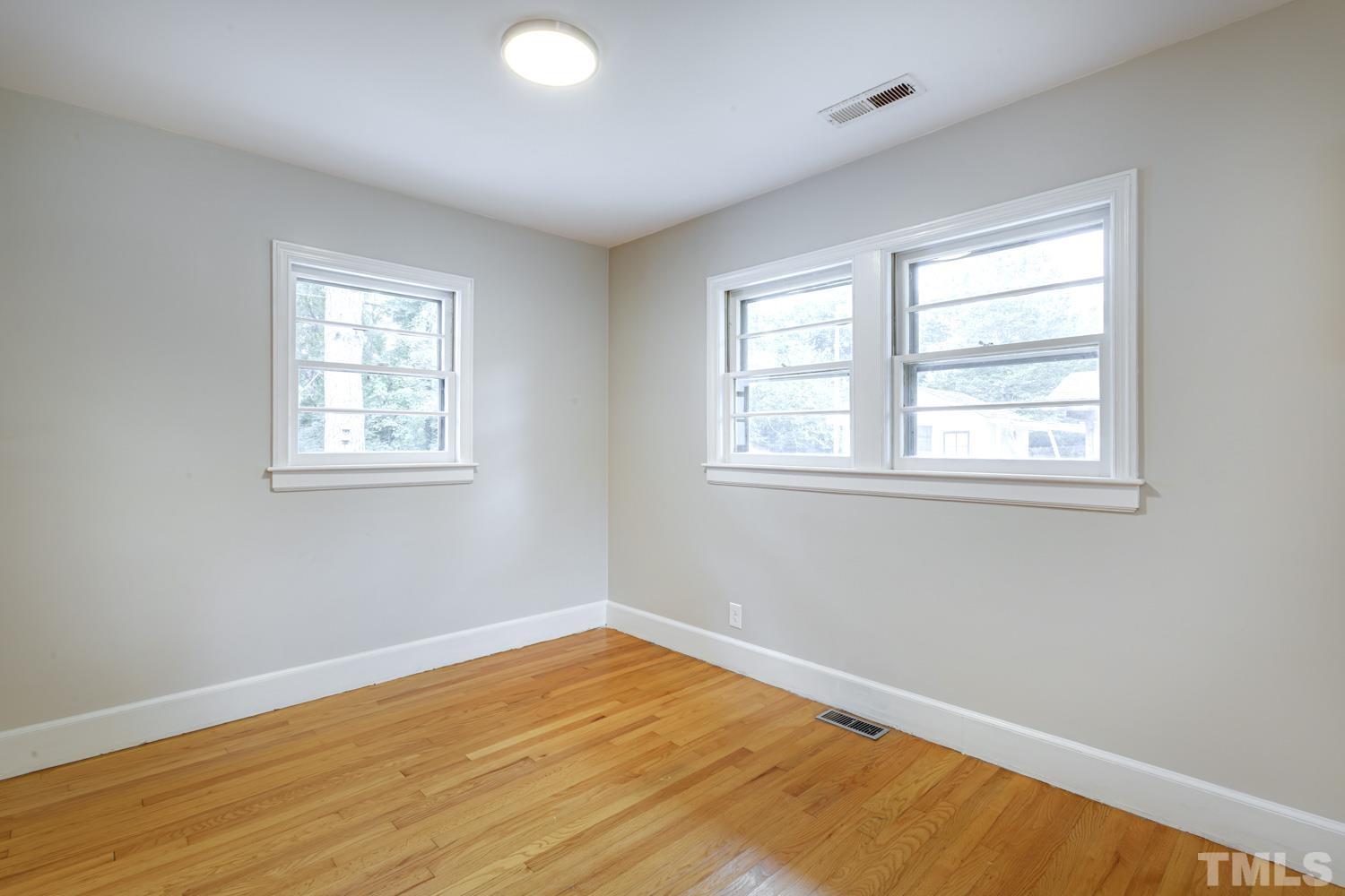 4008 Cheek Road Durham, NC 27704 - Photo 4 of 10 a view of empty room with wooden floor and fan