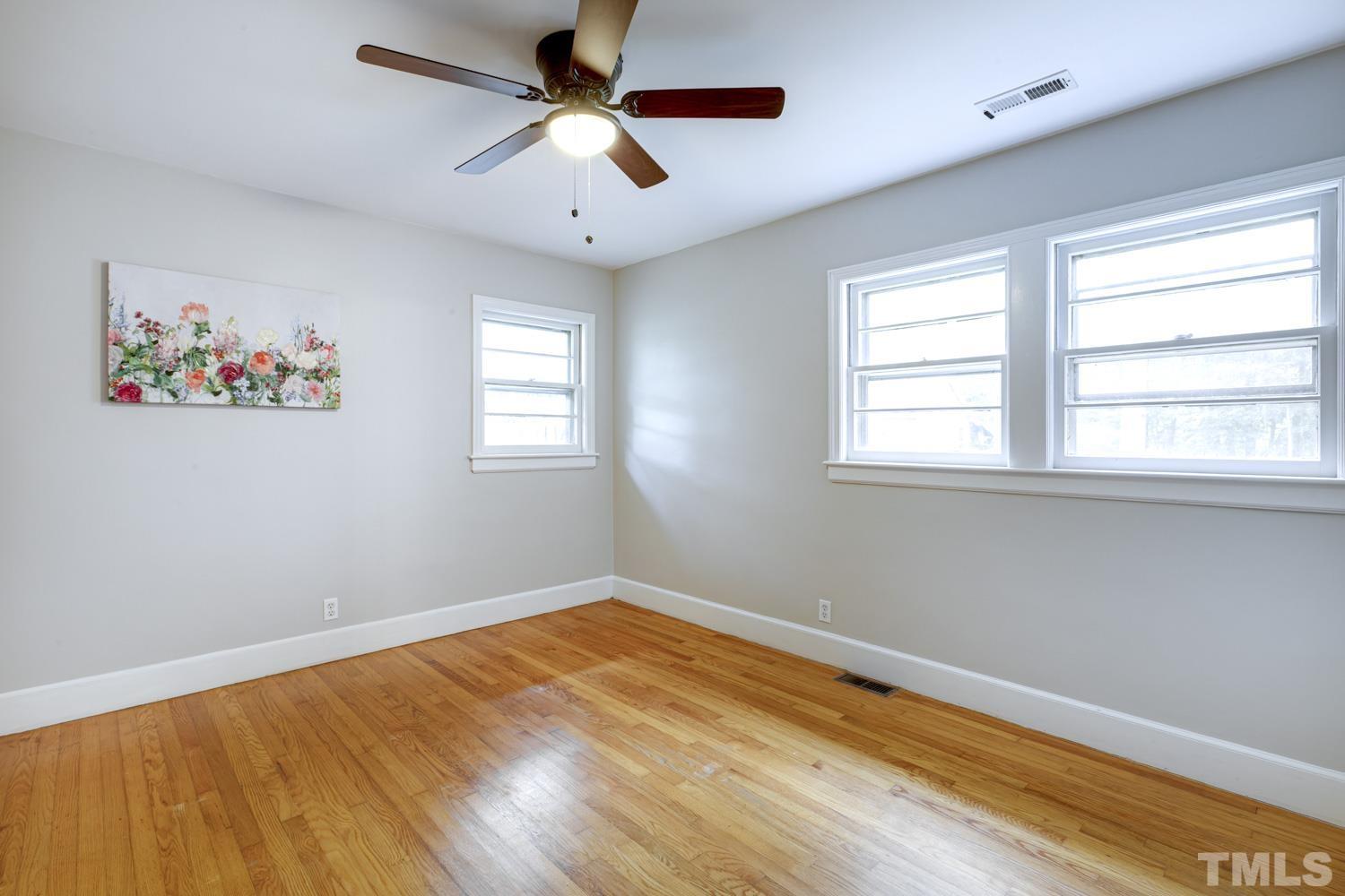 4008 Cheek Road Durham, NC 27704 - Photo 7 of 10 a view of empty room with wooden floor and fan