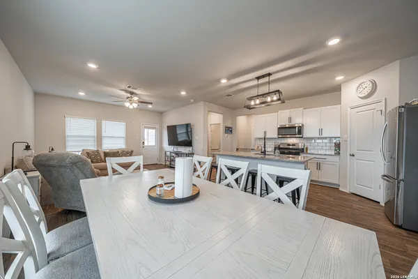 a large kitchen with a table and chairs