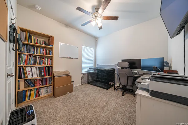 a view of a workspace with furniture and a bookshelf