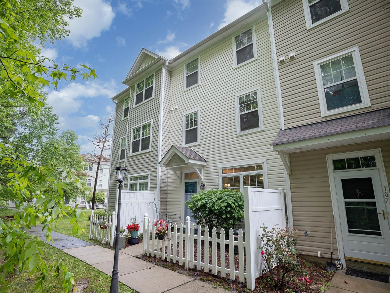 8621 Neuse Club Lane, Unit 109 Raleigh, NC 27616 - Photo 1 of 21 a front view of a house with a garden