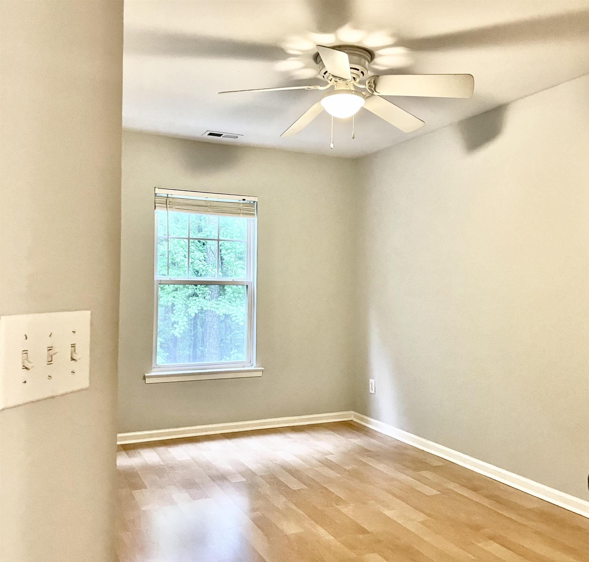 8621 Neuse Club Lane, Unit 109 Raleigh, NC 27616 - Photo 11 of 21 an empty room with windows and fan