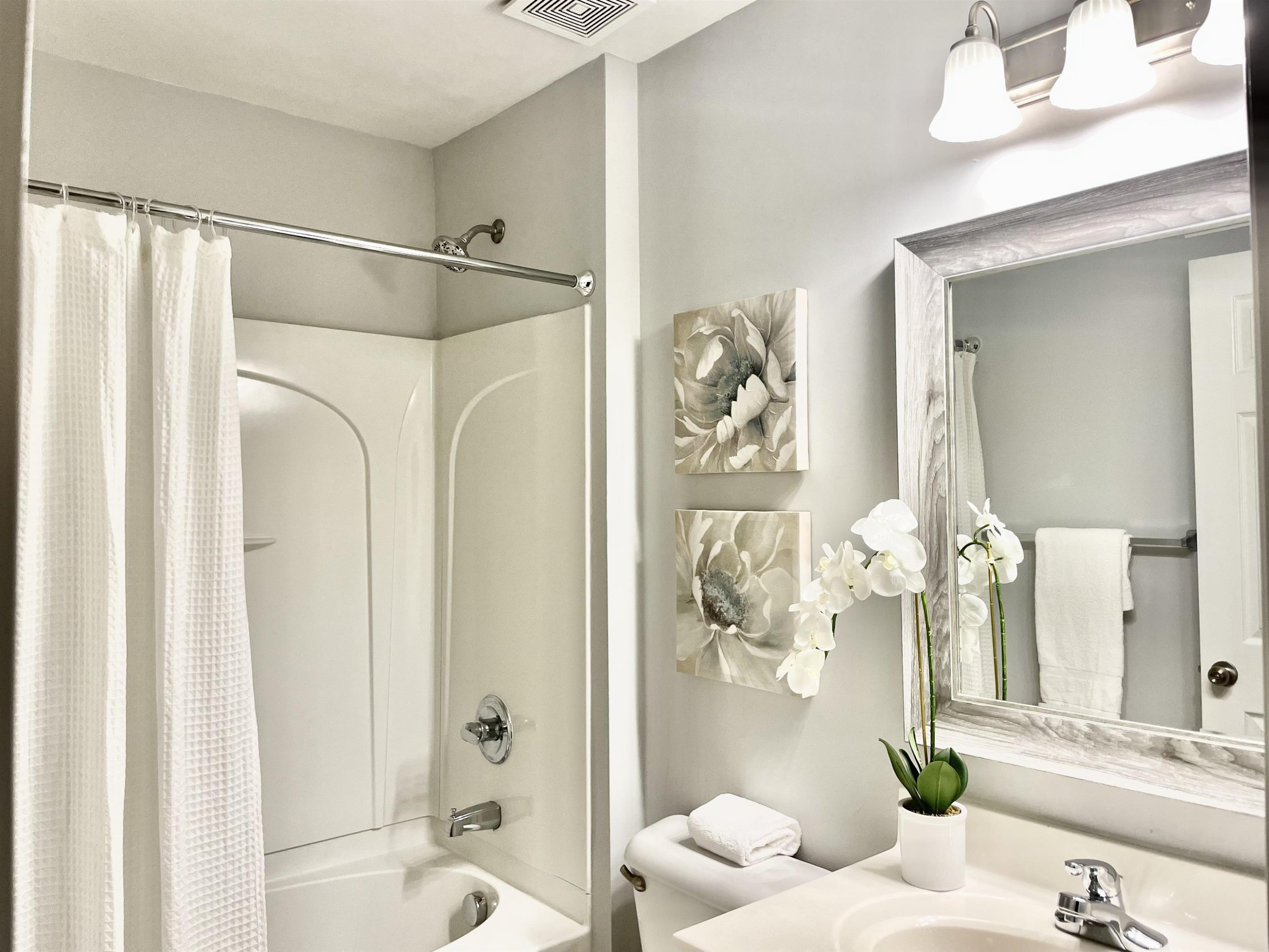 8621 Neuse Club Lane, Unit 109 Raleigh, NC 27616 - Photo 9 of 21 a bathroom with a shower and a mirror
