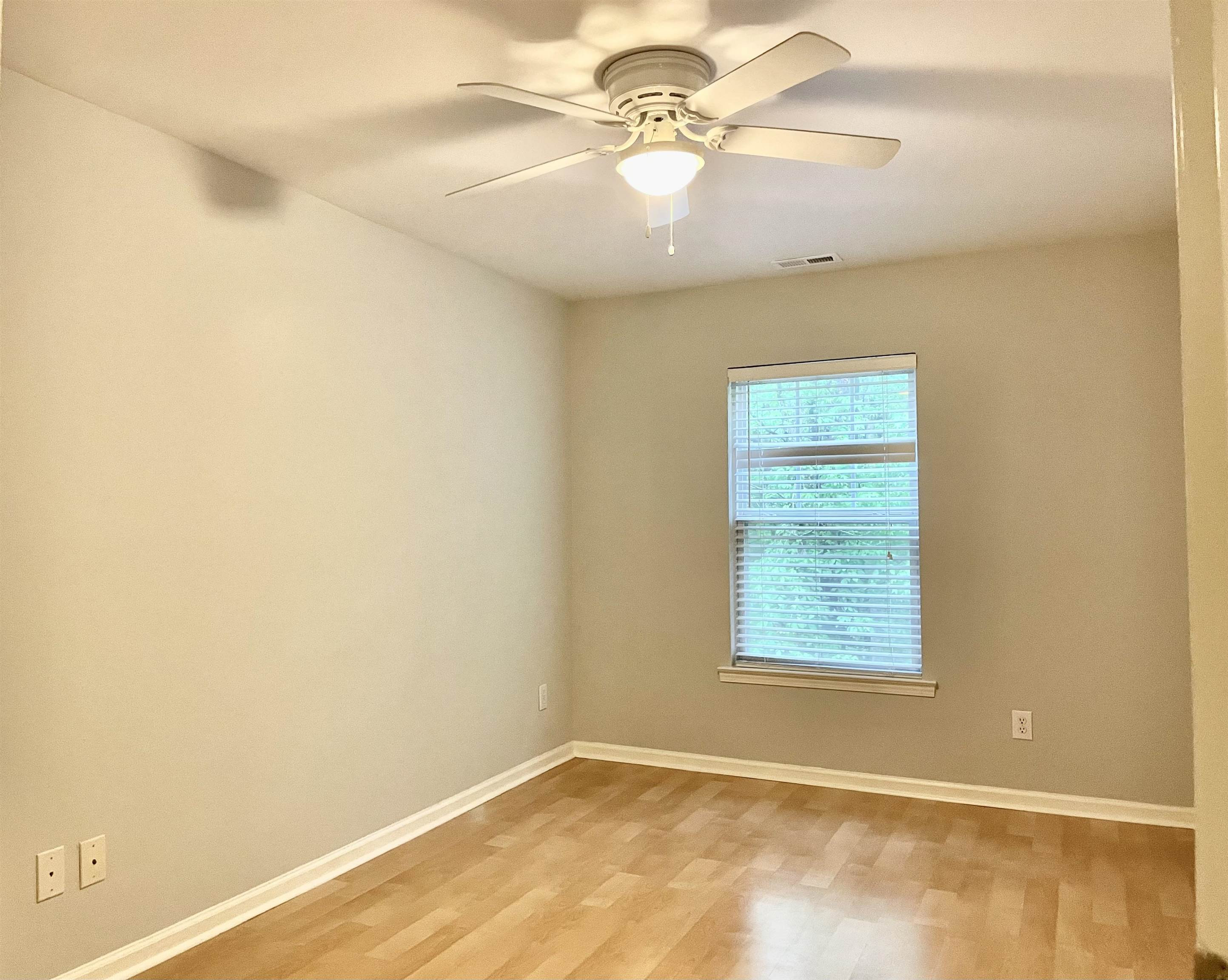 8621 Neuse Club Lane, Unit 109 Raleigh, NC 27616 - Photo 10 of 21 an empty room with a window and a fan