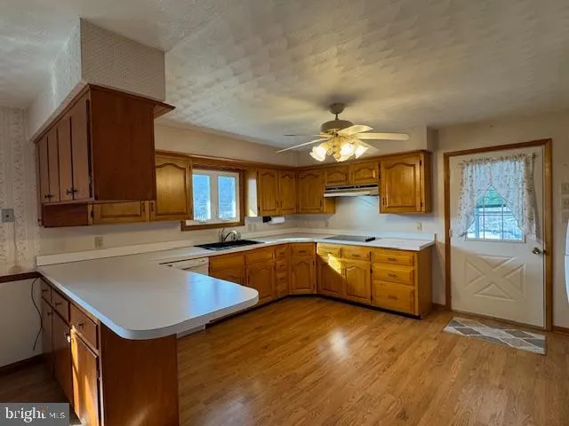 a large kitchen with cabinets and wooden floor