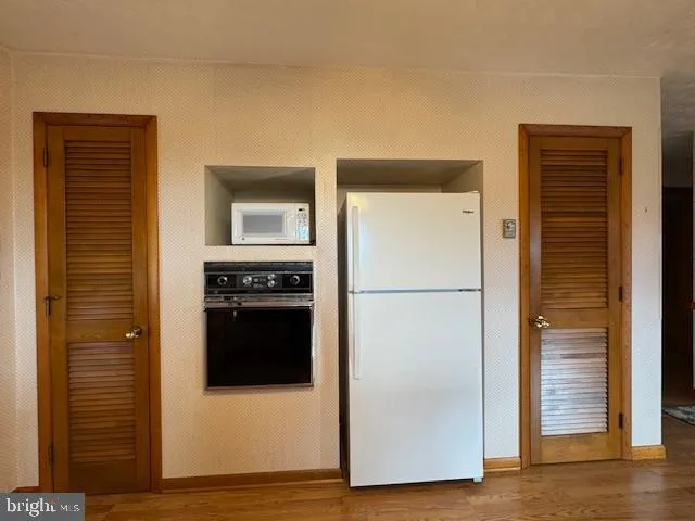 a kitchen with a stove and a refrigerator