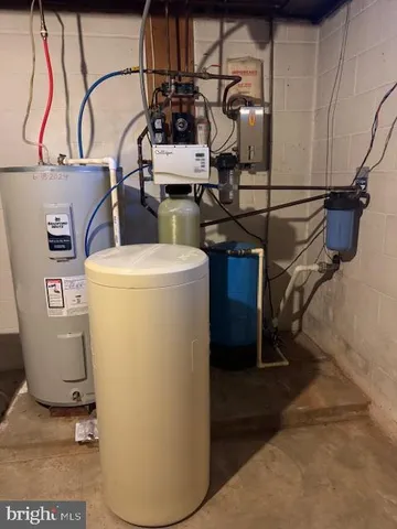 a white toilet sitting next to a white wall