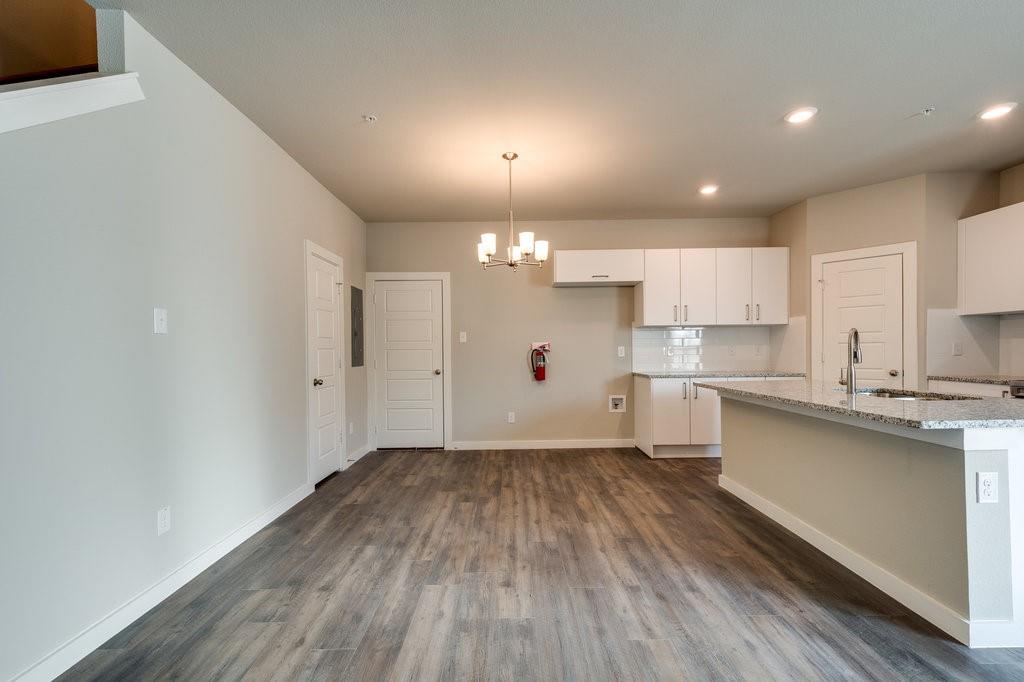 716 Fallow Drive Venus, TX 76084 - Photo 3 of 15 a view of a kitchen with wooden floor and a sink