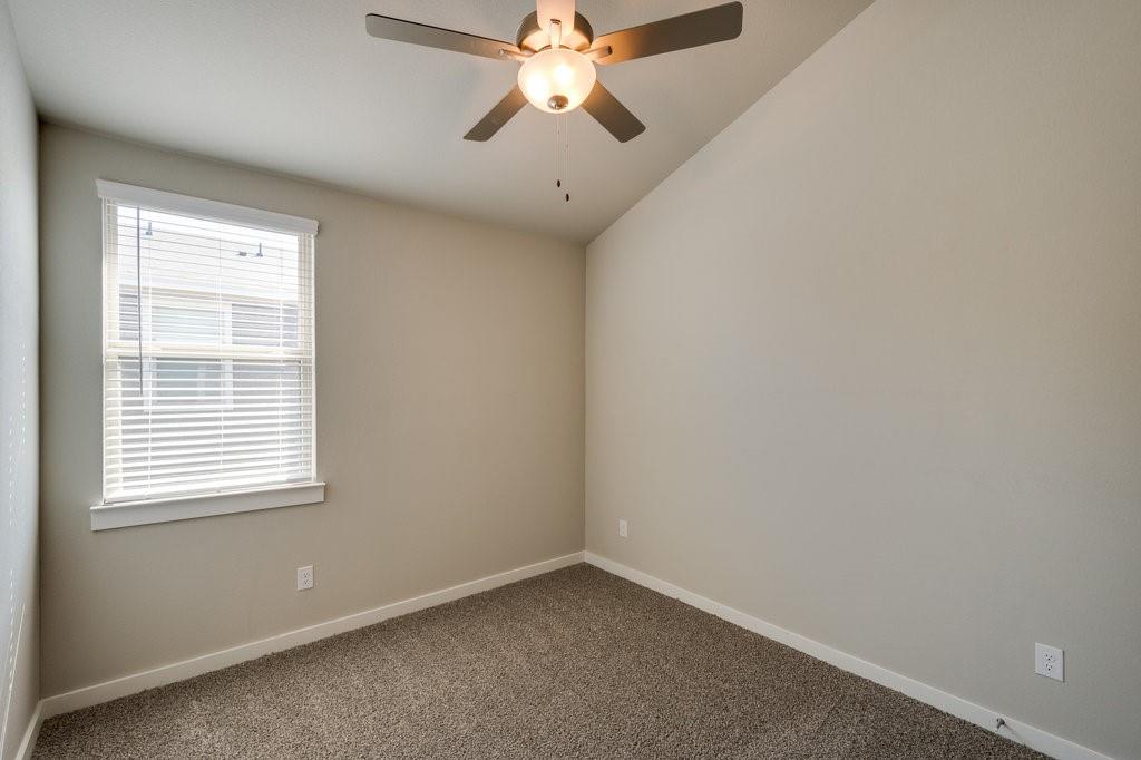 716 Fallow Drive Venus, TX 76084 - Photo 7 of 15 an empty room with window and chandelier fan