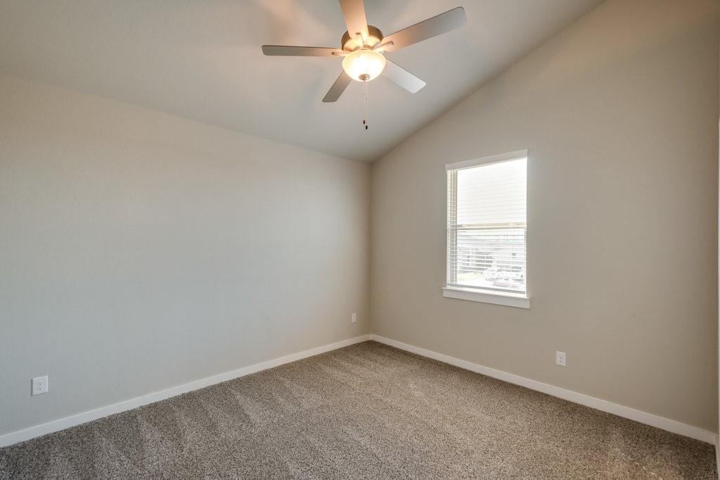 716 Fallow Drive Venus, TX 76084 - Photo 8 of 15 an empty room with a window and a fan