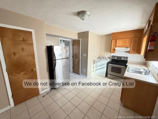 6467 Yadkin Road, Unit 6 Fayetteville, NC 28303 - Photo 3 of 8 a kitchen with stainless steel appliances a refrigerator and a stove top oven