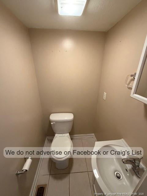 6467 Yadkin Road, Unit 6 Fayetteville, NC 28303 - Photo 4 of 8 a bathroom with a sink and a toilet