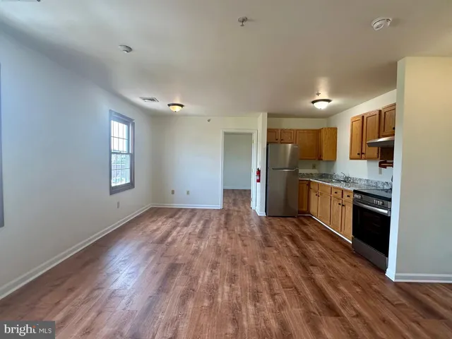 a view of kitchen with sink and wooden floor