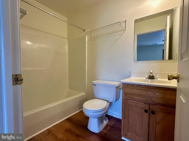 a bathroom with a granite countertop toilet a sink and a bathtub