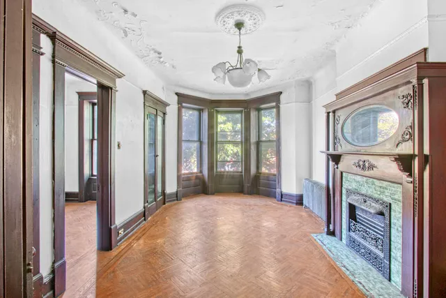a view of a livingroom with workspace and a window