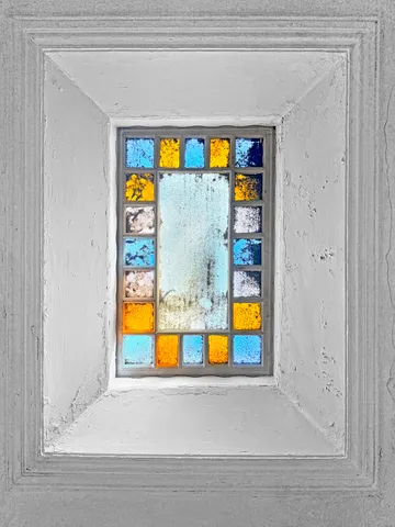 a bedroom with a bed next to a window and a flat screen tv