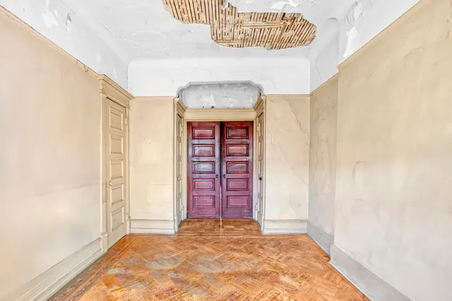 view of hall way with wooden floor and windows