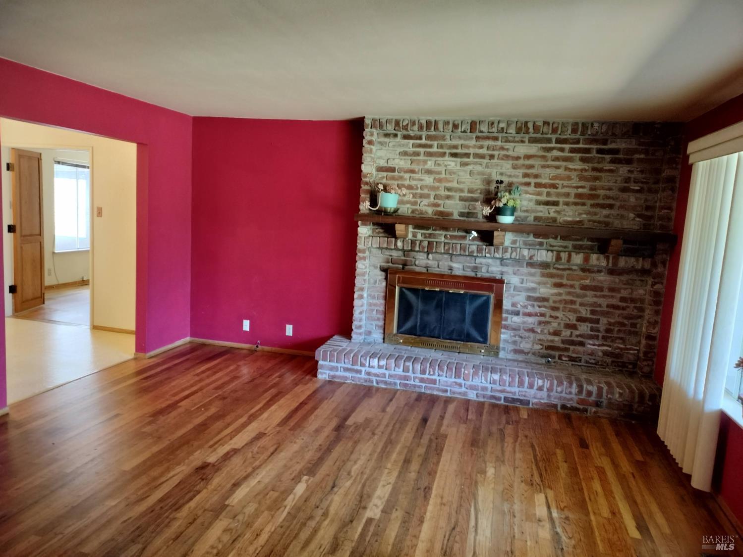 7149 Lynch Road Sebastopol, CA 95472 - Photo 2 of 25 a view of an empty room with wooden floor and a fire place