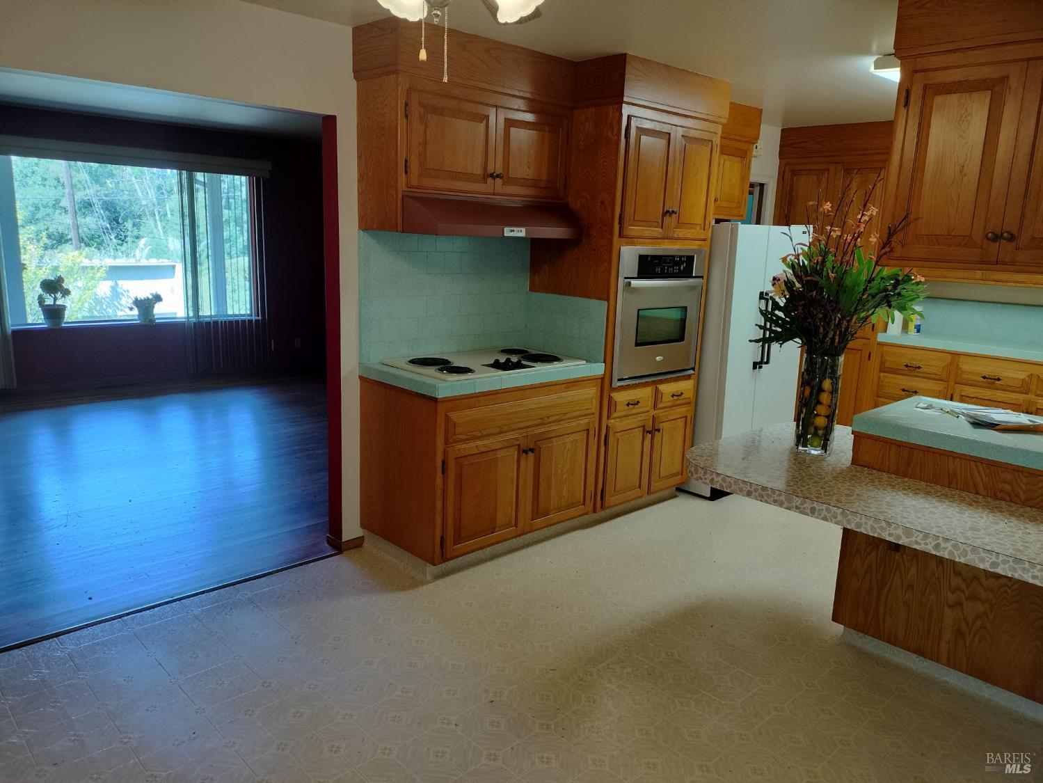7149 Lynch Road Sebastopol, CA 95472 - Photo 4 of 25 a kitchen with stainless steel appliances granite countertop a stove a refrigerator and a more cabinets