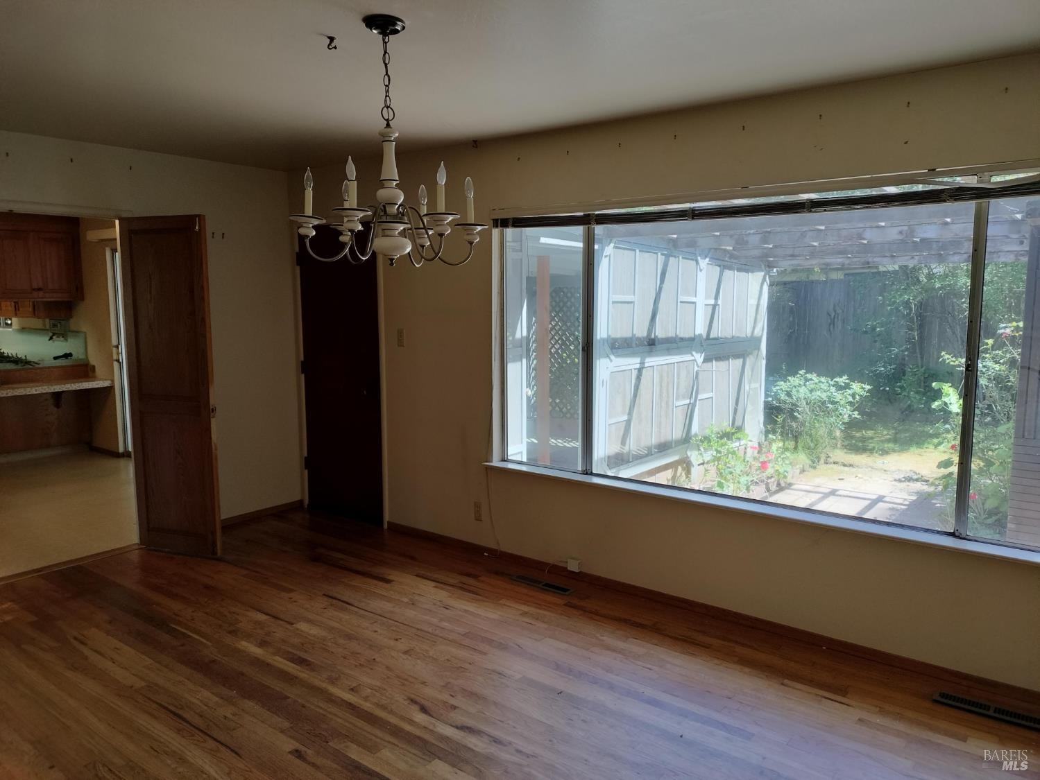 7149 Lynch Road Sebastopol, CA 95472 - Photo 9 of 25 a view of a room with wooden floor a ceiling fan and windows