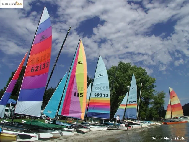 a view of multi story residential apartment building with space and tall trees