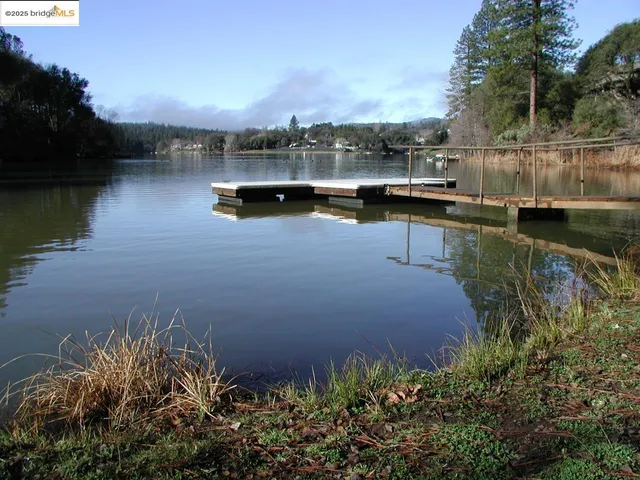 a view of a lake with a house in the background