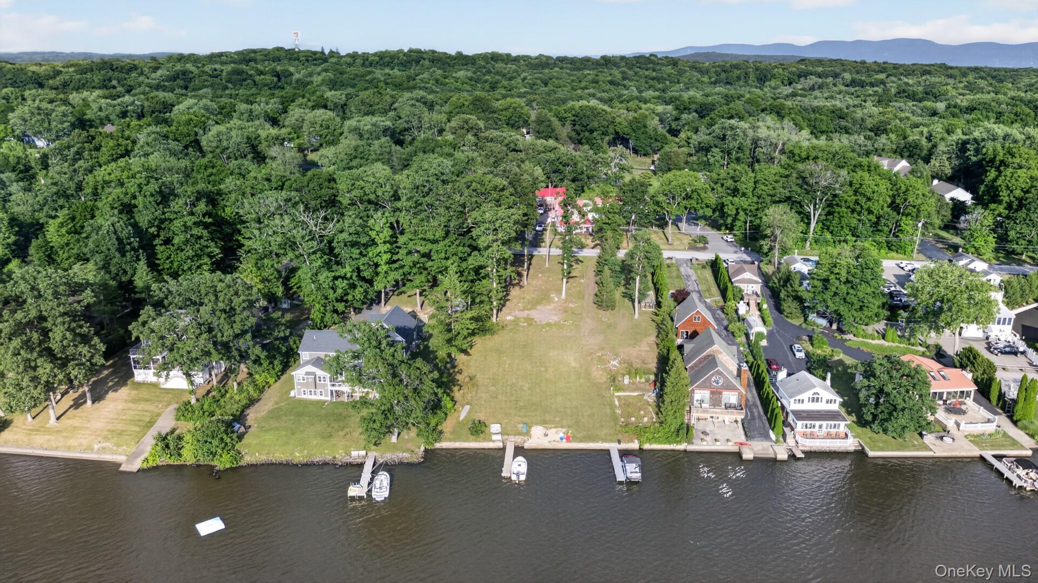 355 Lakeside Road Newburgh, NY 12550 - Photo 13 of 14 Waterfront property featuring a private dock, expansive green space, and mature trees