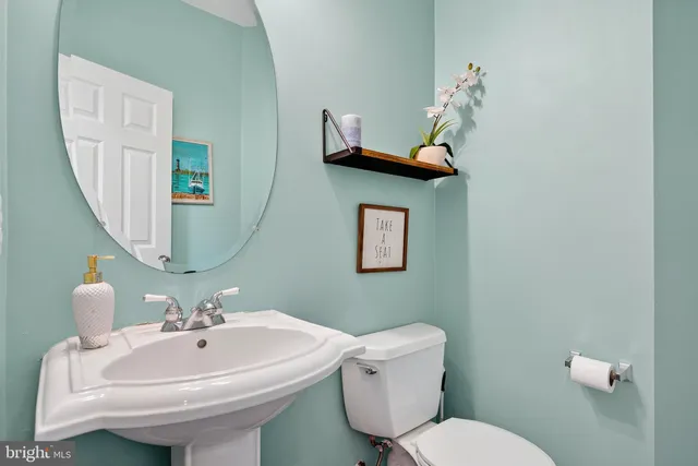 a spacious bedroom with a bed a dresser and a chandelier