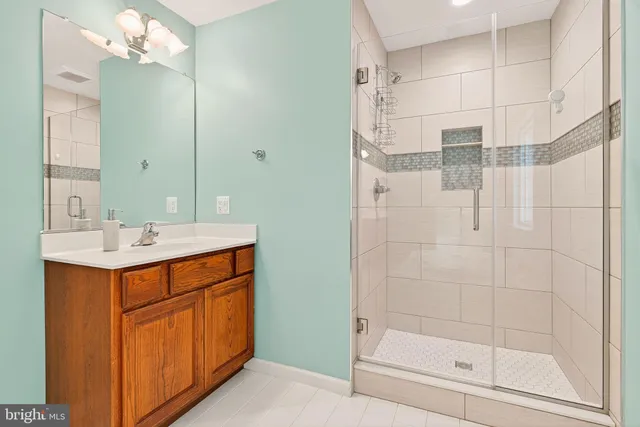 a white bath tub sitting in a bathroom next to a window